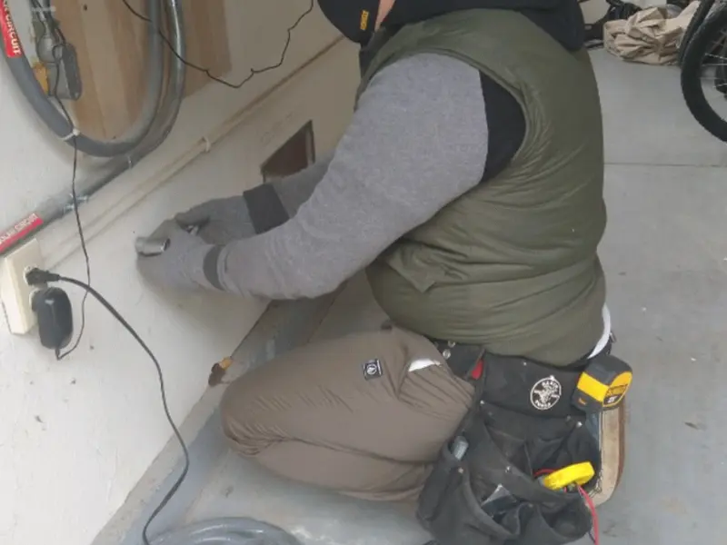 Electrician performing outlet wiring in a Weston Lakes garage